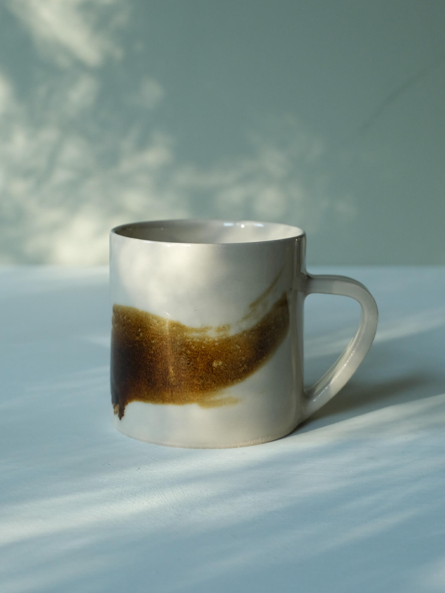 Handmade ceramic mug with brushstroke design