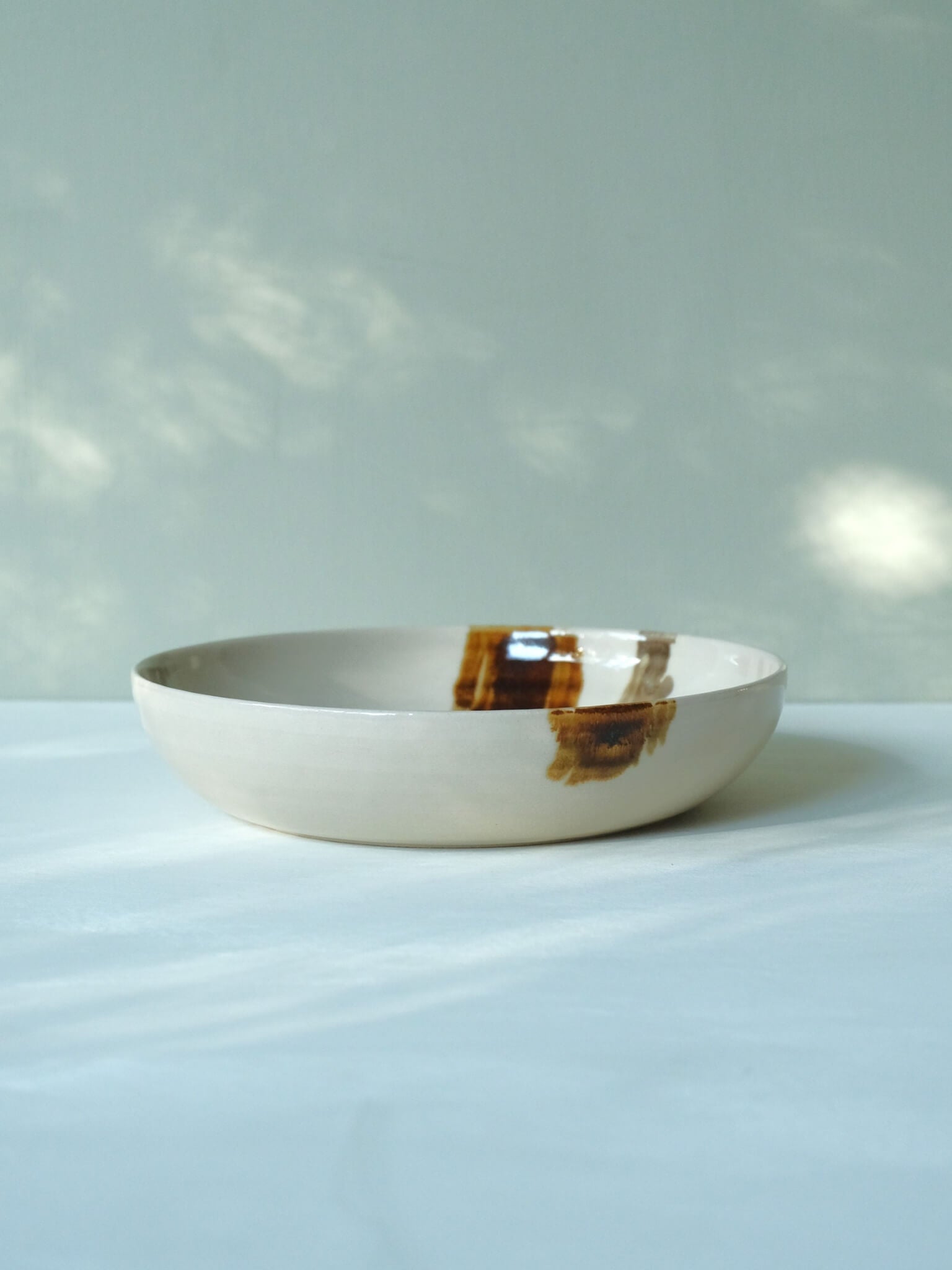 Wide ceramic dinner bowl with brushstroke design