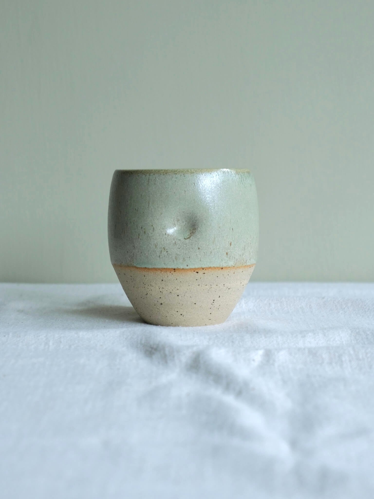 Dimple cup with seafoam glaze, made by Florence Ceramics