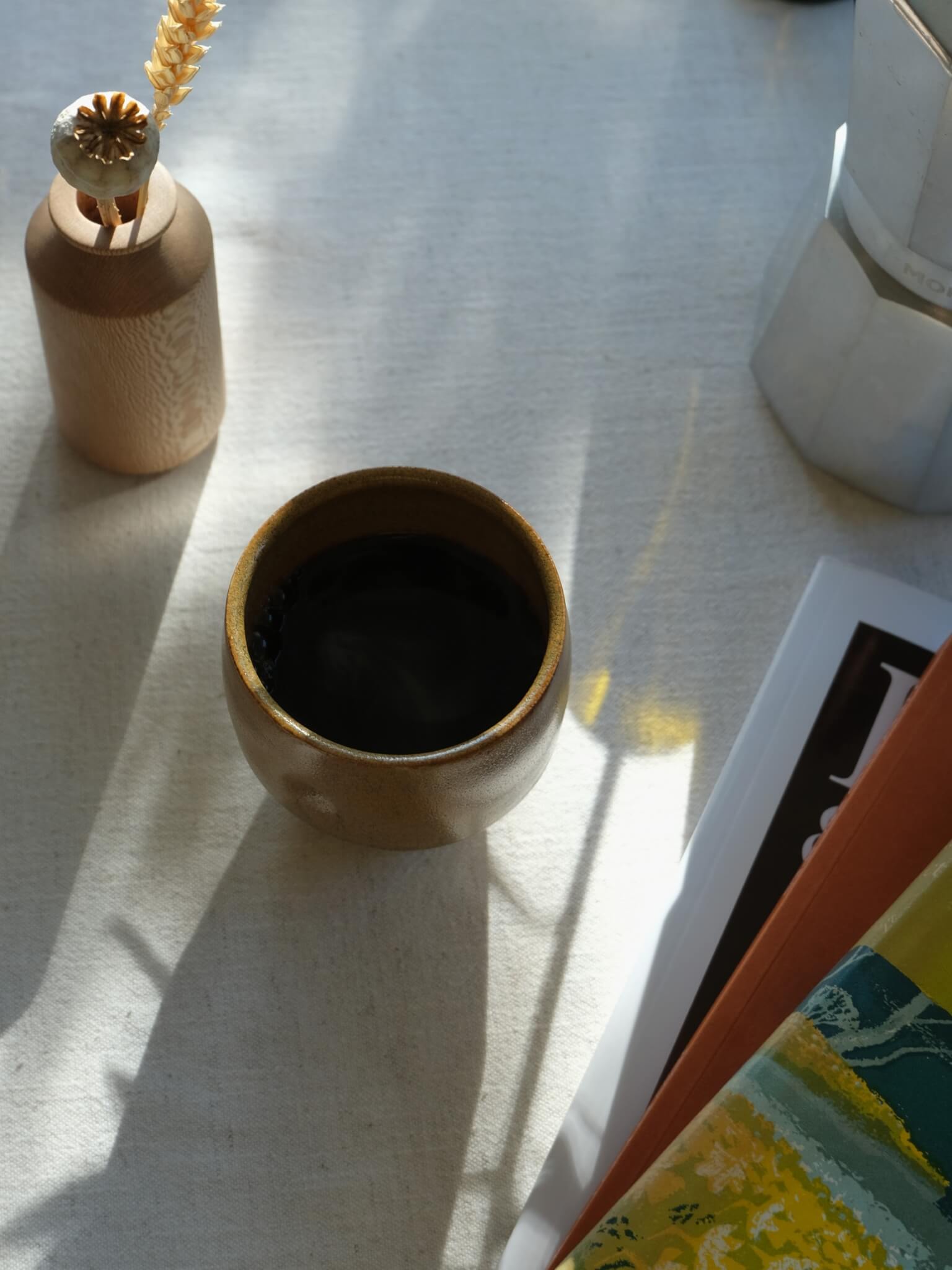 Dimple cup with umber glaze, made by Florence Ceramics