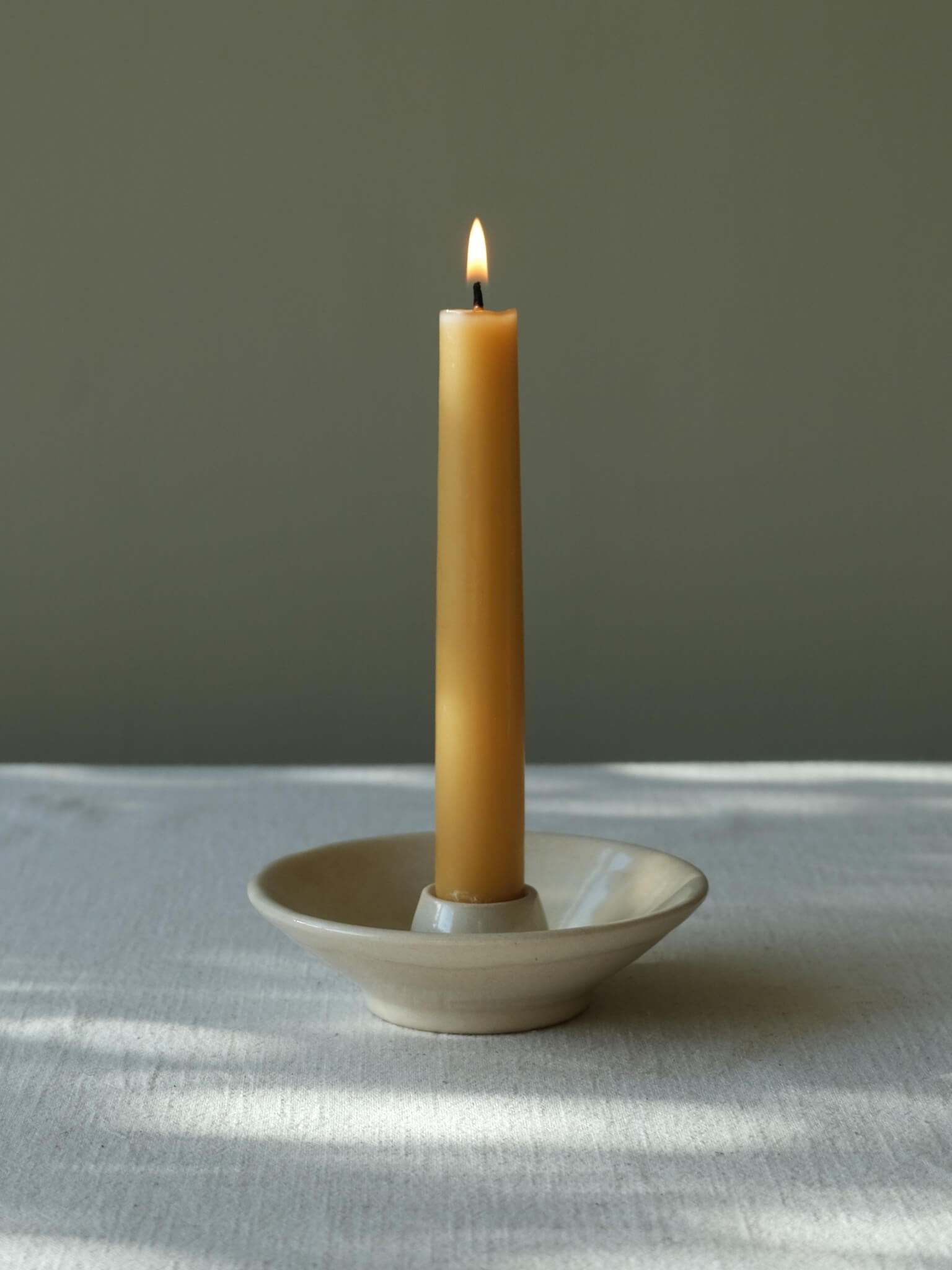 Ceramic candle dish with buttermilk glaze, handmade by Sophia McEvoy