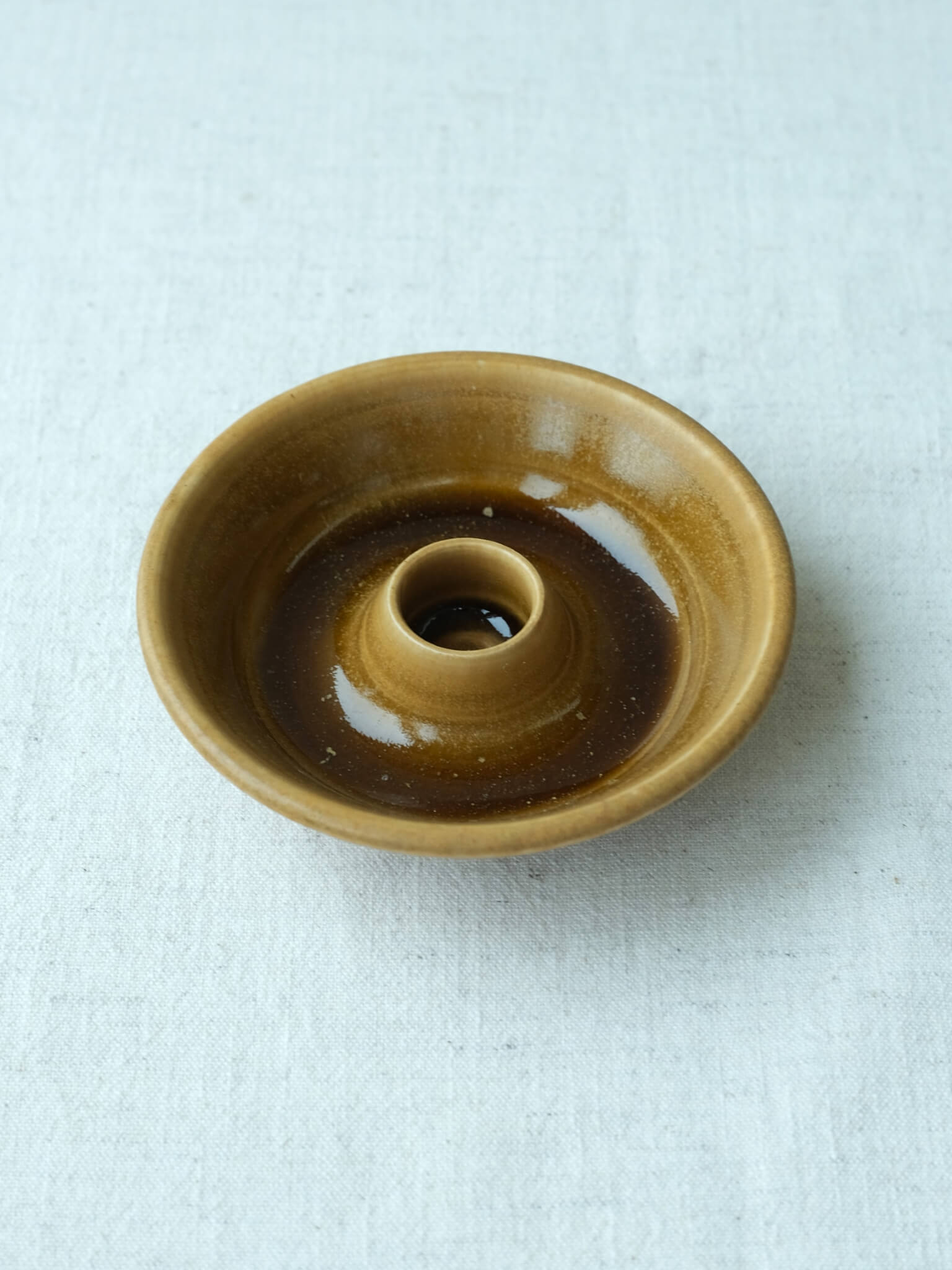 Ceramic candle dish with toffee glaze, handmade by Sophia McEvoy