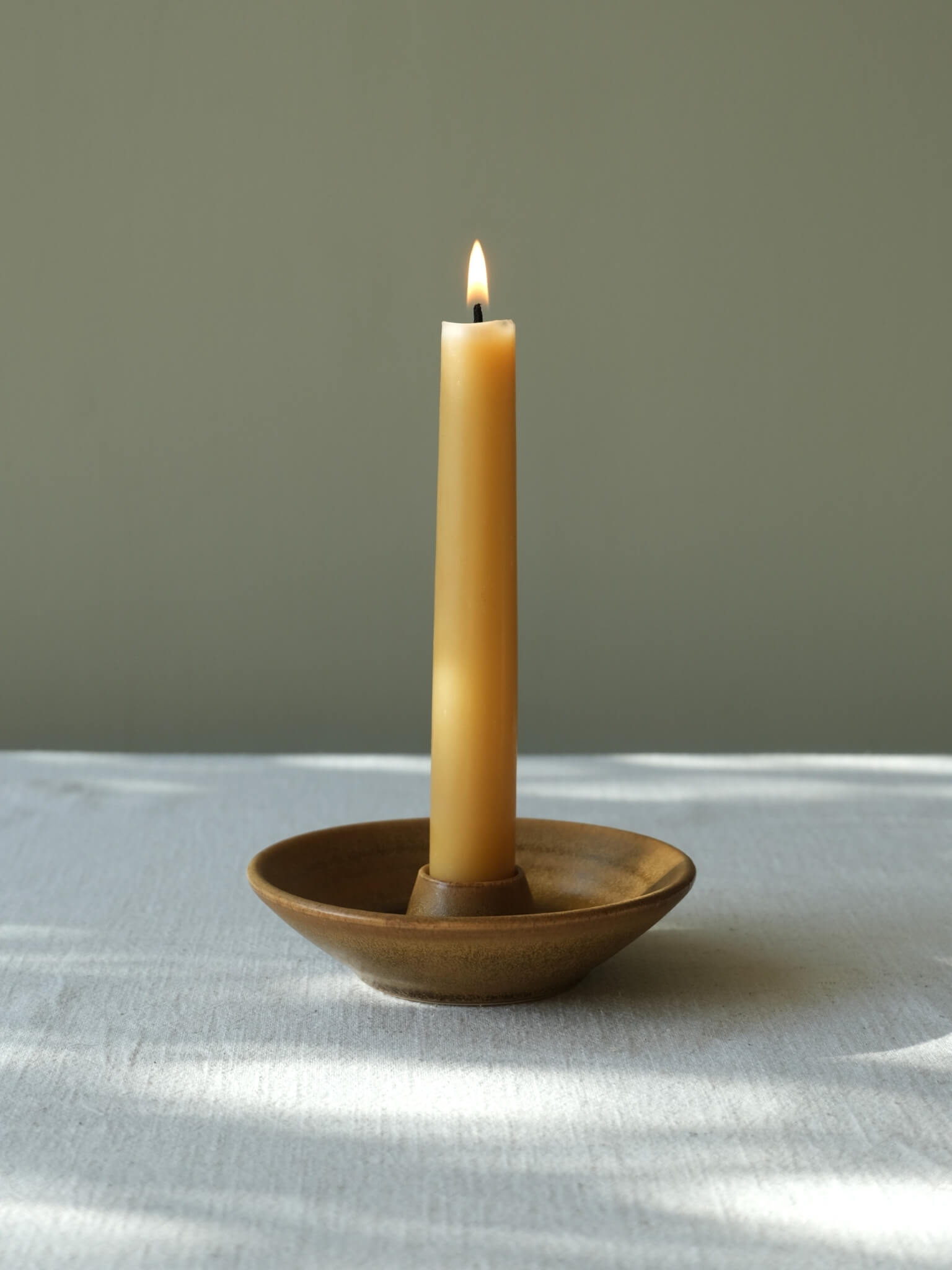 Ceramic candle dish with toffee glaze, handmade by Sophia McEvoy