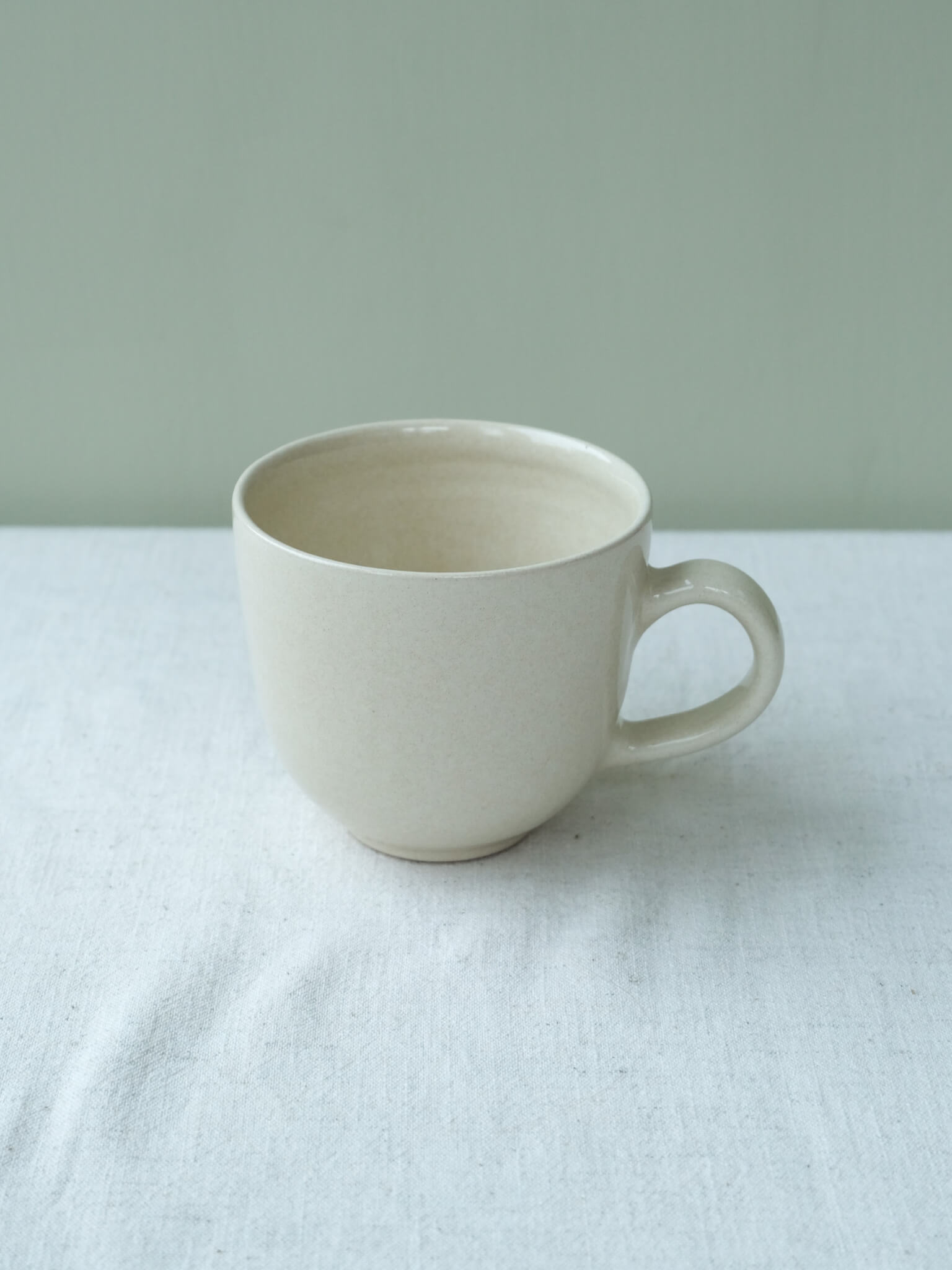 Handmade tea mug with buttermilk glaze, by Sophia McEvoy