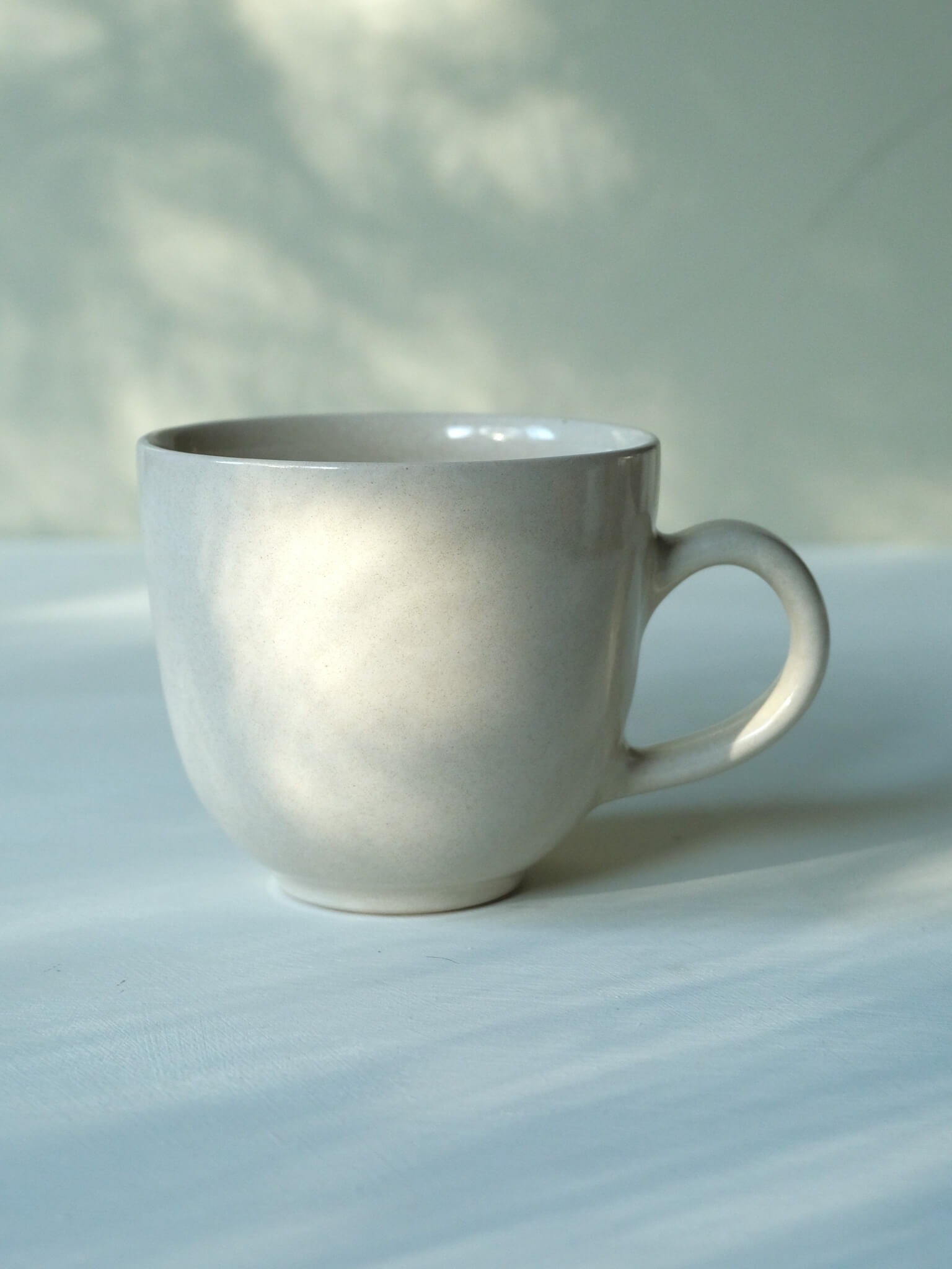 Handmade tea mug with buttermilk glaze, by Sophia McEvoy