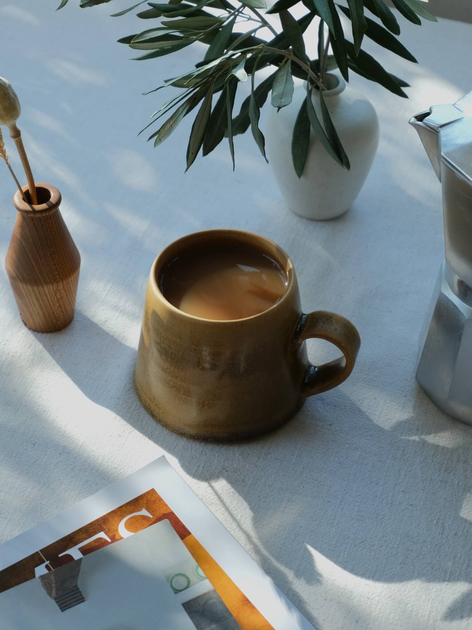 Stoneware taper mug with toffee glaze, made by Sophia McEvoy